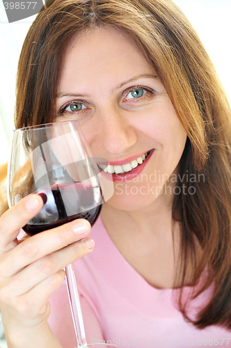 Image of Mature woman with a glass of red wine