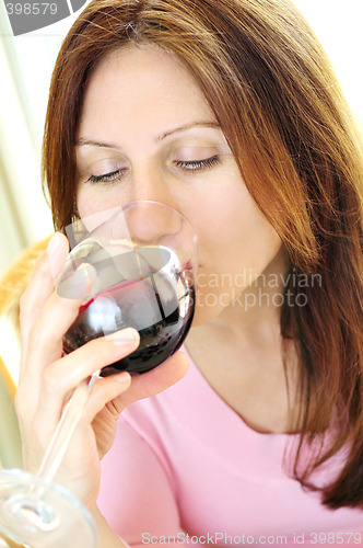 Image of Mature woman with a glass of red wine