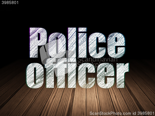 Image of Law concept: Police Officer in grunge dark room