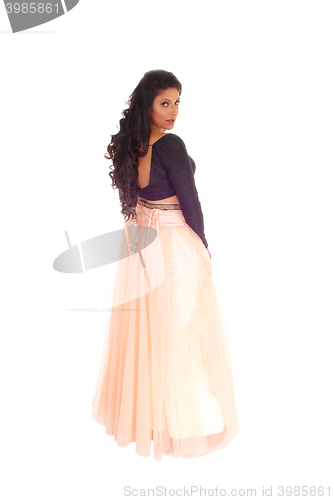 Image of Woman standing in long pink skirt.