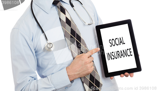 Image of Doctor holding tablet - Social insurance
