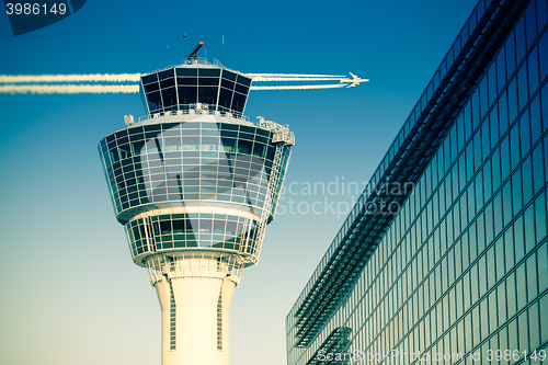 Image of Flights management air control tower passenger terminal and flying plane