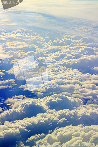 Image of Clouds pass under wing of plane