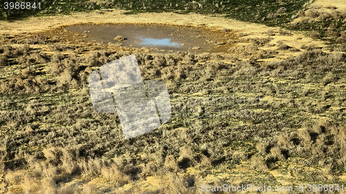 Image of Drought. Slowly drying pond in steppe, where there was watering hole of wild mammals and birds