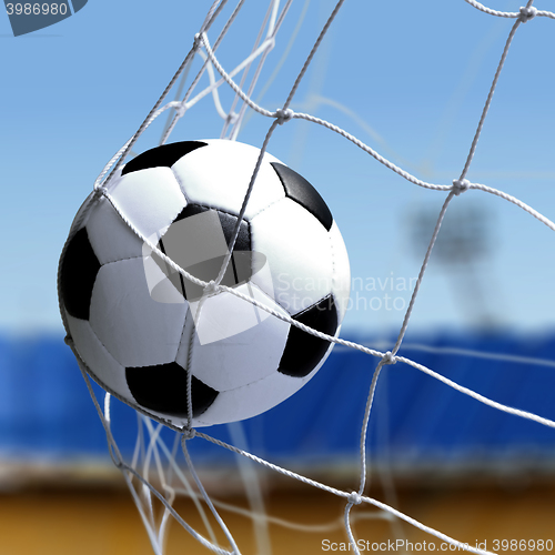 Image of soccer ball is in goal net