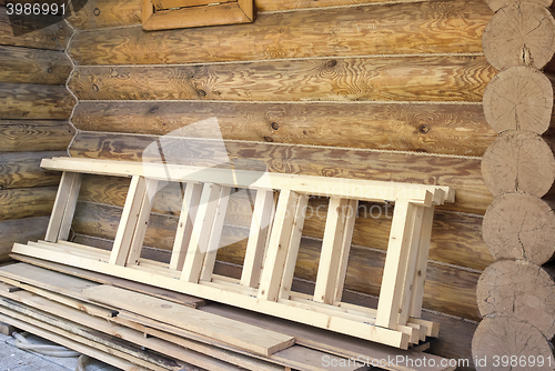 Image of Wooden stairs and timber house wall.