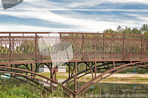 Image of Metal bridge over a small river.