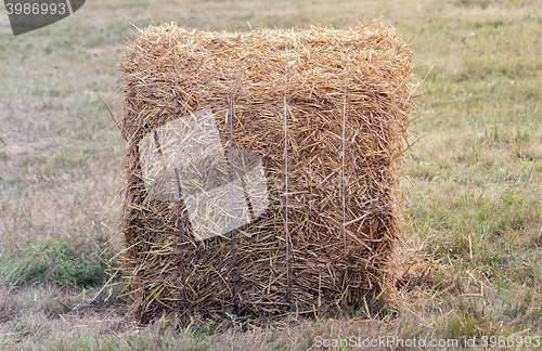 Image of A bale of straw on a field after harvest.