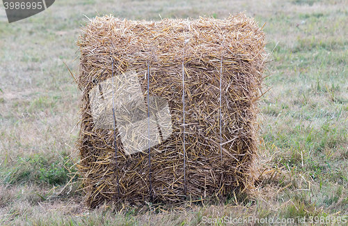 Image of A bale of straw on a field after harvest.