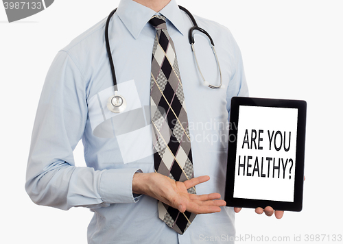 Image of Doctor holding tablet - Are you healthy?