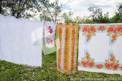 Image of In the garden on a rope dried laundered linen.