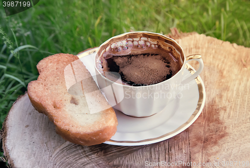 Image of Still life: a Cup of black coffee in the garden.