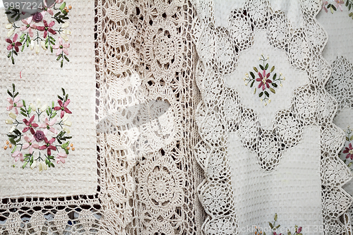 Image of Tablecloths and napkins, decorated with embroidery and lace.