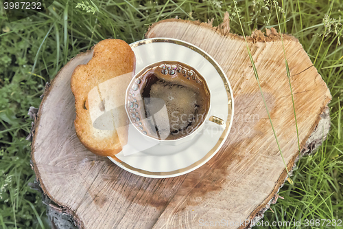 Image of Still life: a Cup of black coffee in the garden.