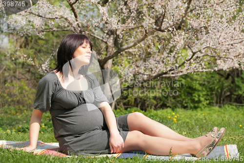 Image of expectant mother in blossom garden