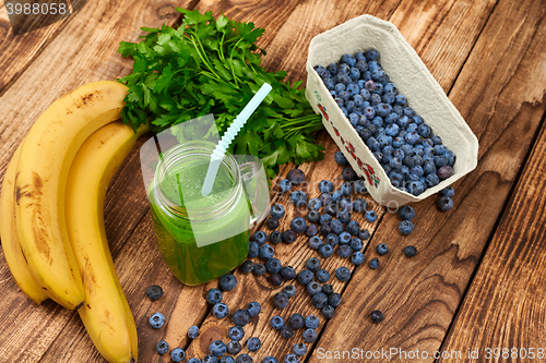 Image of Mug with green smoothie drink and bundle of fresh parsley