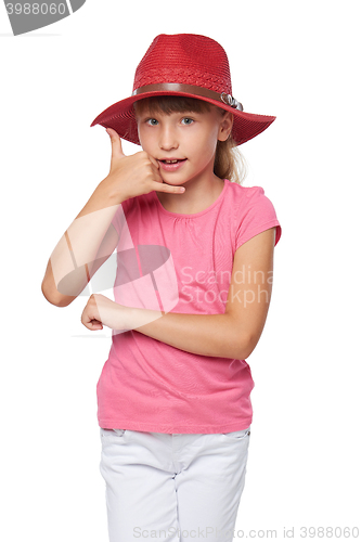 Image of Little girl in traveler hat making a call me gesture