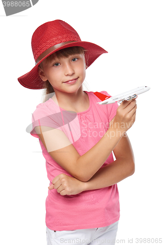 Image of Lovely little girl wearing tourist hat holding small airplane toy