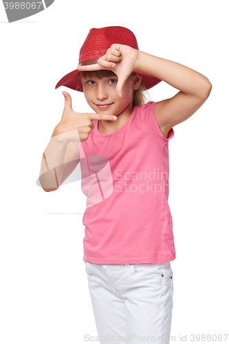 Image of Little girl wearing traveler hat making frame with her hands