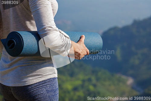 Image of Woman standing with yoga 