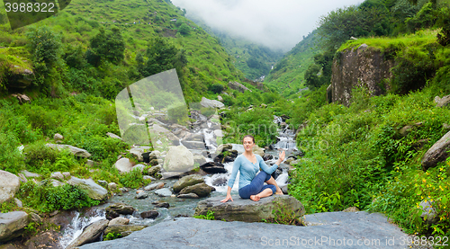 Image of Woman doing Ardha matsyendrasanaasana asana outdoors