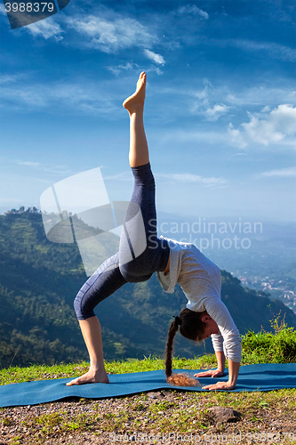 Image of Woman doing yoga asana outdoors