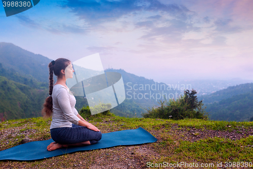 Image of Woman doing Yoga asana Virasana Hero pose