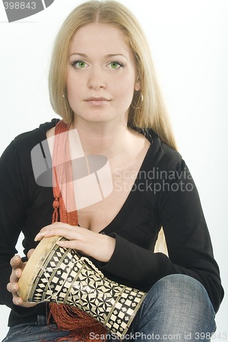 Image of green-eyed pretty blonde with djembe