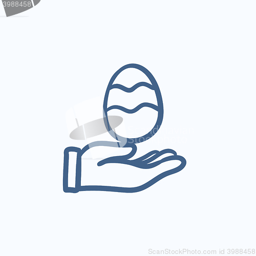 Image of Hand holding easter egg sketch icon.