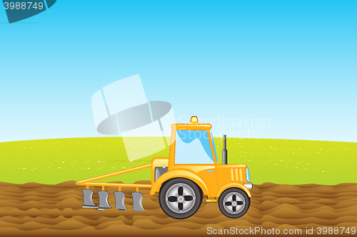 Image of Tractor plows land in field