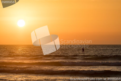 Image of Man paddleboarding