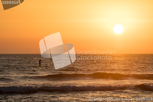 Image of Man paddleboarding