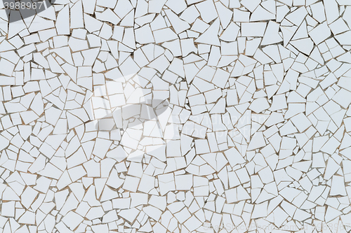 Image of White broken tiles wall