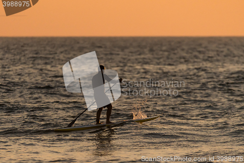 Image of Man paddleboarding