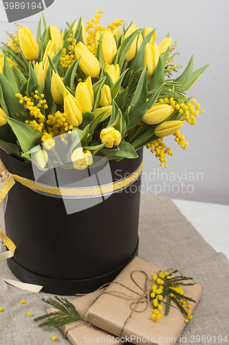 Image of Bright spring bouquet of tulips and mimosa flowers