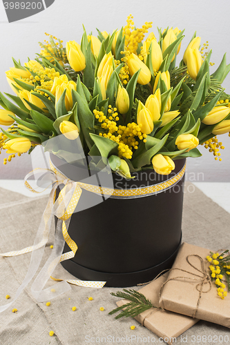 Image of Bright spring bouquet of tulips and mimosa flowers