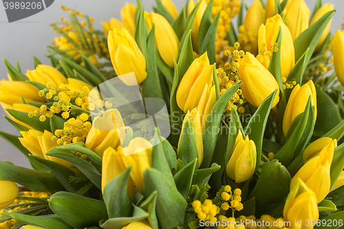 Image of Bright spring bouquet of tulips and mimosa flowers