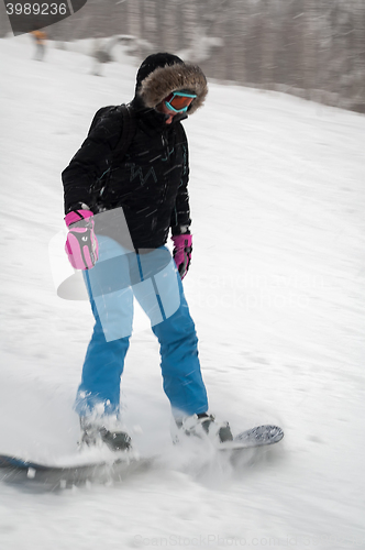 Image of Woman doing exercise on snowboard