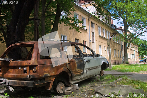 Image of Burned-down vehicle on yard of residental house