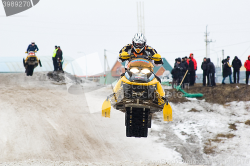 Image of Jump of sportsman on snowmobile