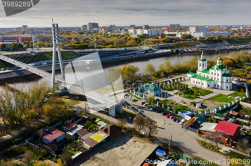 Image of Pedestrian Lovers Bridge and church. Tyumen.Russia