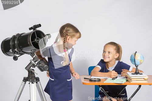 Image of The two girls looked at each other in the classroom Astronomy