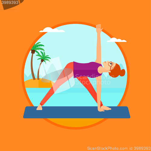 Image of Woman practicing yoga triangle pose on the beach.