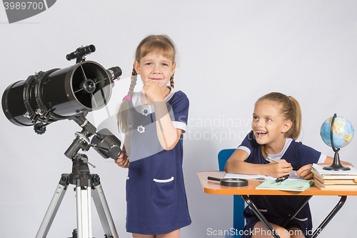 Image of Girl astronomer thought, another girl with a smile looking at her