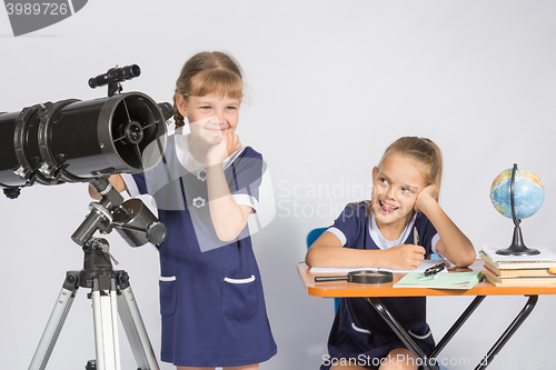 Image of Girl mysteriously astronomer looks into the distance, a classmate with a smile looked at her