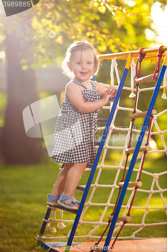 Image of The little baby girl playing at outdoor playground