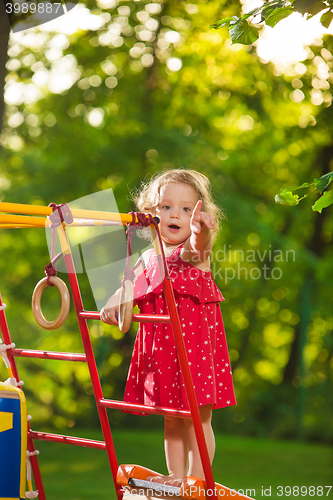 Image of The little baby girl playing at outdoor playground