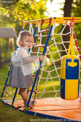 Image of The little baby girl playing at outdoor playground