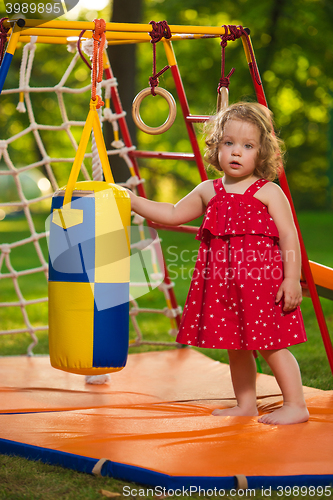 Image of The little baby girl playing at outdoor playground