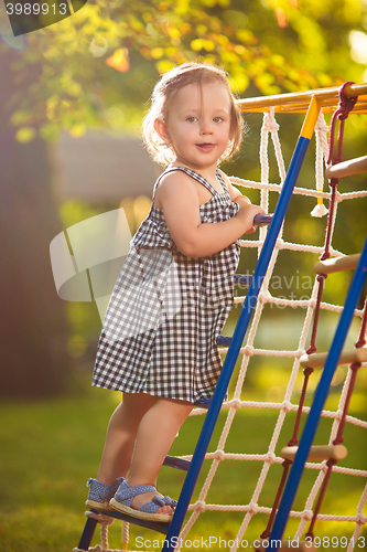 Image of The little baby girl playing at outdoor playground